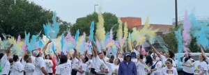 people in a color run throwing colors in the air